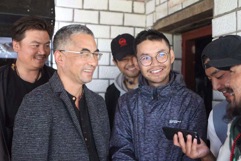 Pema Tseden (left, in square-framed glasses) and Lhapal Gya (right, in round glasses). Courtesy of Lhapal Gya 