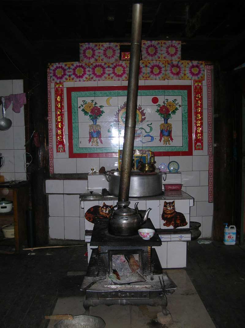 Le poêle au milieu de la cuisine dans une maison à la frontière entre le Sichuan et le Tibet (photo JPDes., 2007) Le poêle au milieu de la cuisine dans une maison à la frontière entre le Sichuan et le Tibet (photo JPDes., 2007)